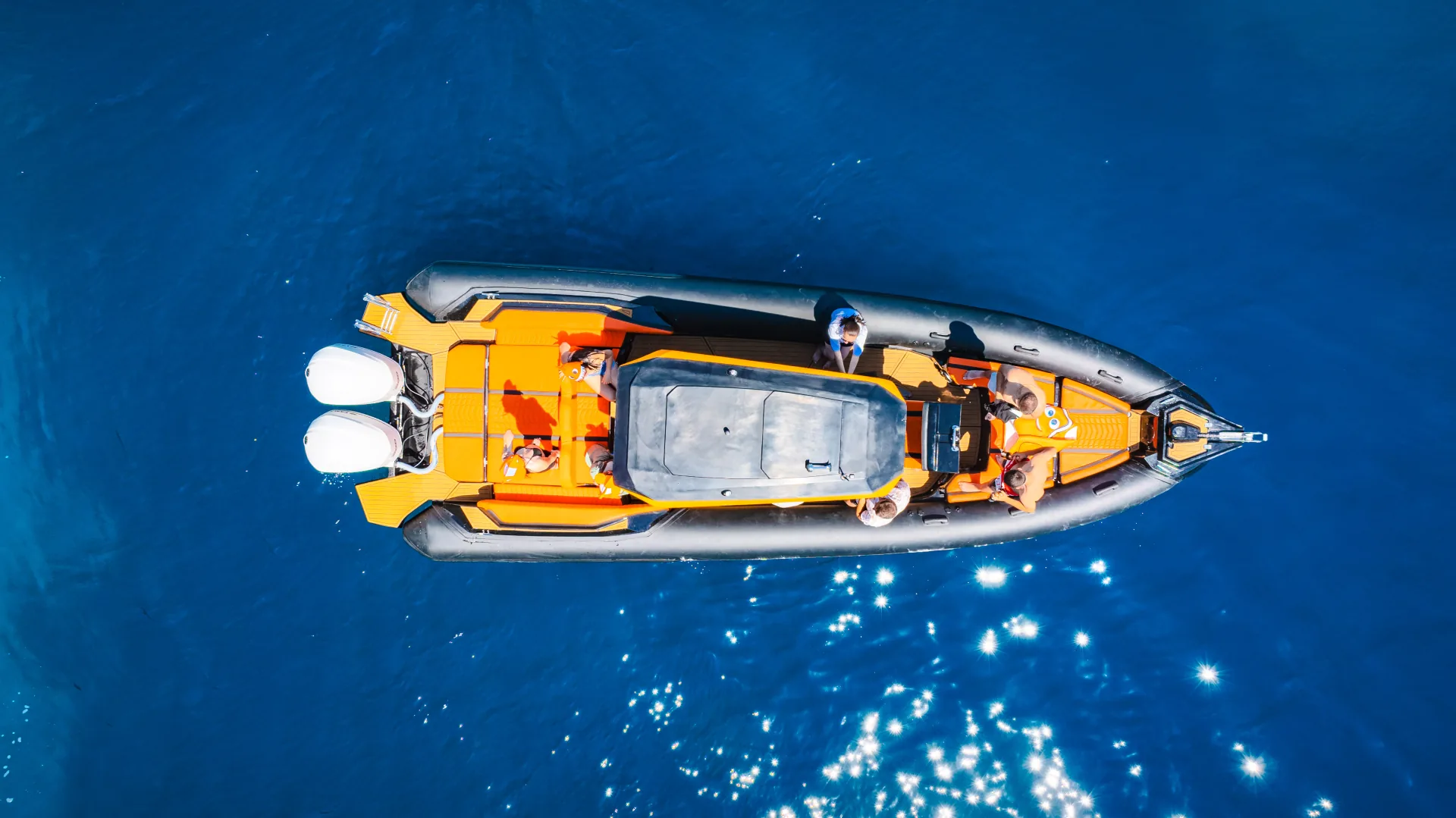 Aerial drone view of the Nemo Boat speeding through deep blue Albanian Riviera water