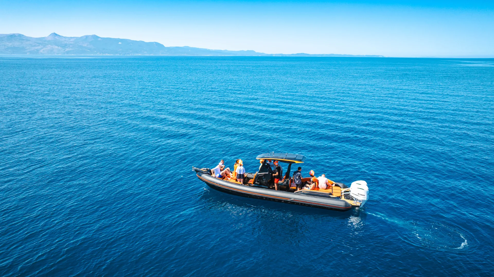Aerial drone view of the Nemo Boat with guests on board in the open sea between Saranda and Corfu