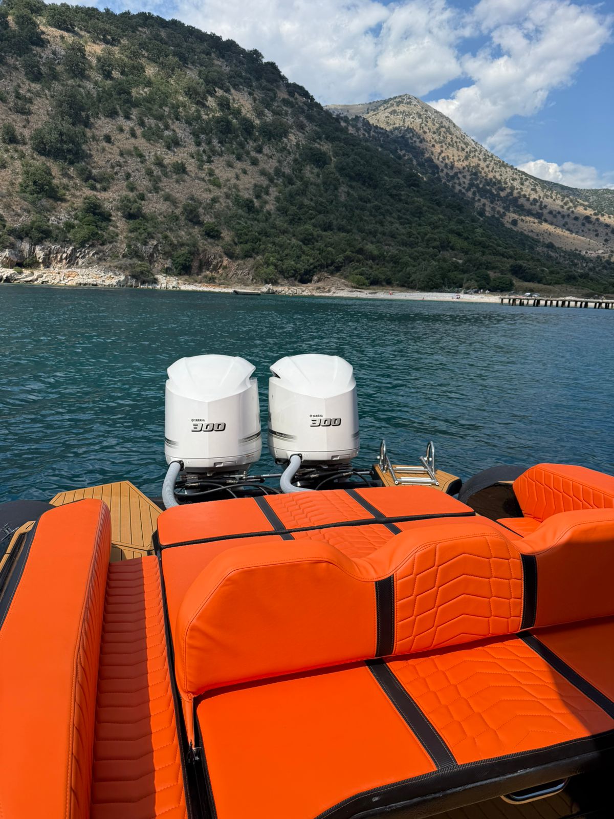 Twin Yamaha 300 HP engines on the Nemo Boat with an Albanian Riviera cove and mountains behind