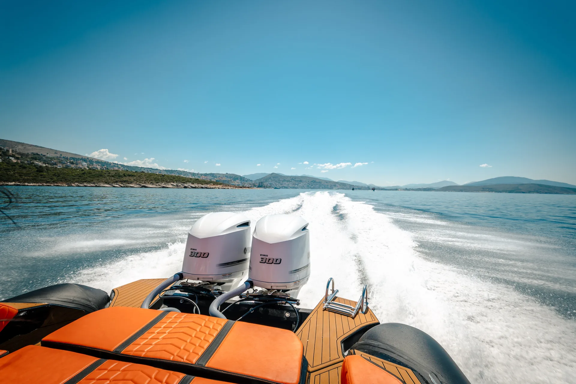 Twin Yamaha 300 HP outboards on the Nemo Boat leaving a long white wake across the Albanian Riviera